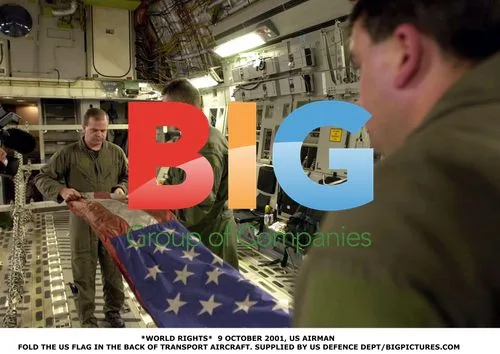 US Airmen Folding Flag in Transport Plane