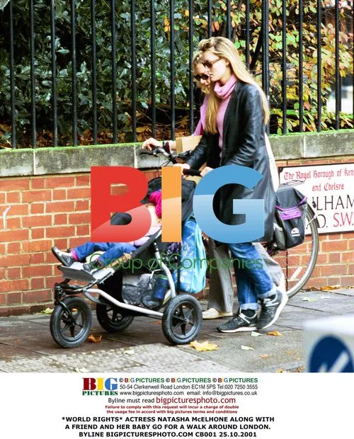 Natasha McElhone walks with friend and baby in London