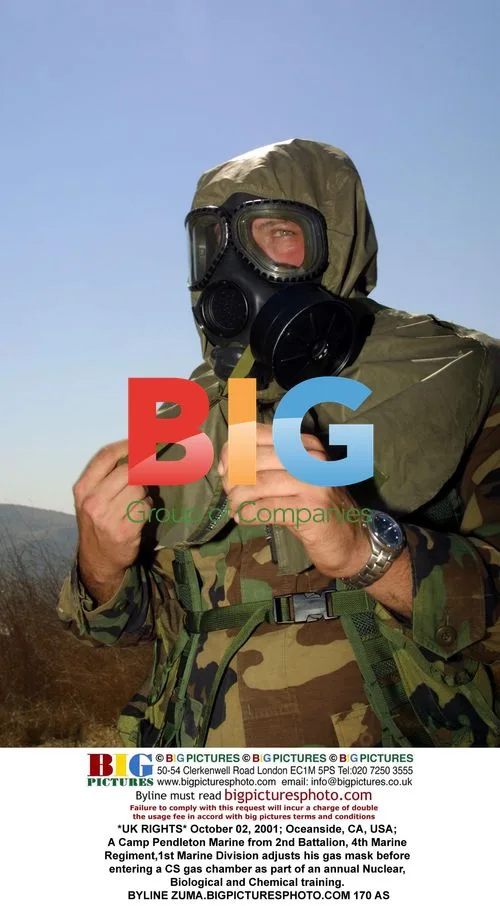 Marine adjusts gas mask for NBC training