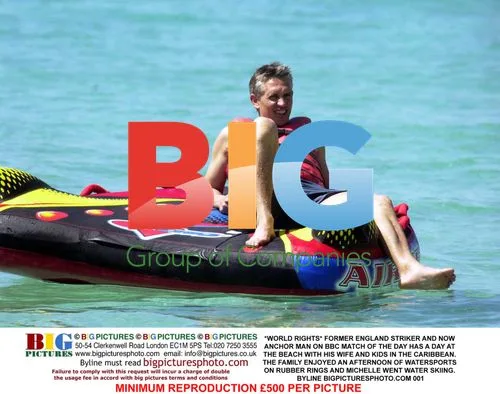 Former England striker enjoys family beach day