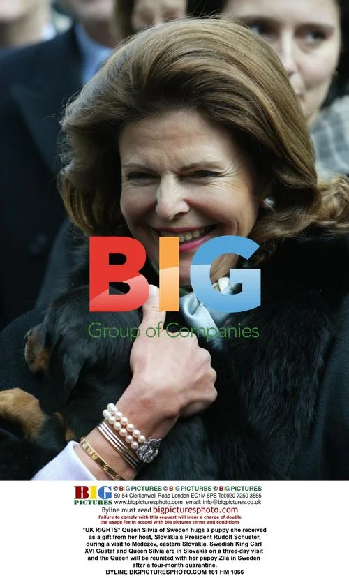 Queen Silvia Hugs Puppy Gift in Slovakia