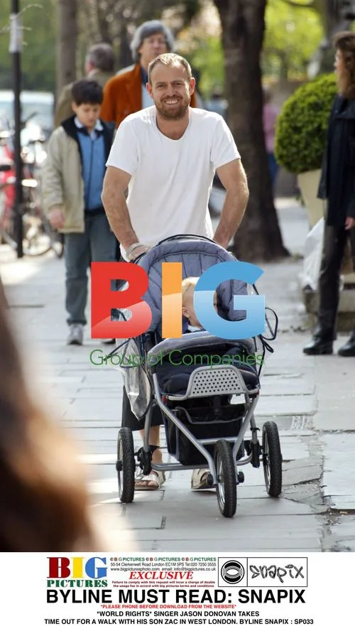 Jason Donovan takes walk with son Zac