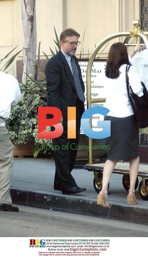 Robert Deniro appears upset while leaving hotel