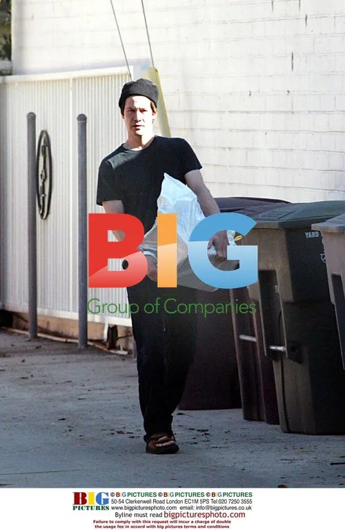 Keanu Reeves takes trash to dumpster