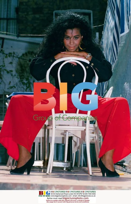 Shirley Lewis in red trousers and black jacket