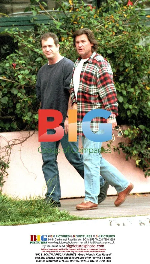 Kurt Russell and Mel Gibson laugh after dinner
