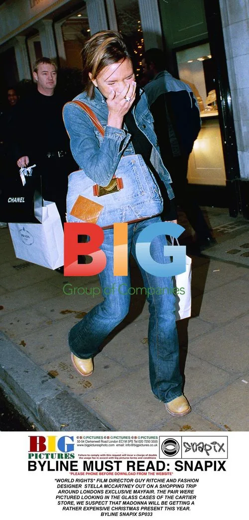 Posh Spice Laughs at Photographers