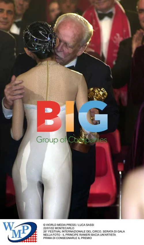 Prince Rainier kisses circus performer at Gala