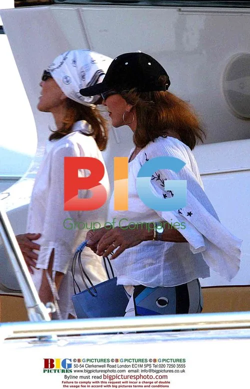 Joan Collins and friend on yacht in St. Tropez