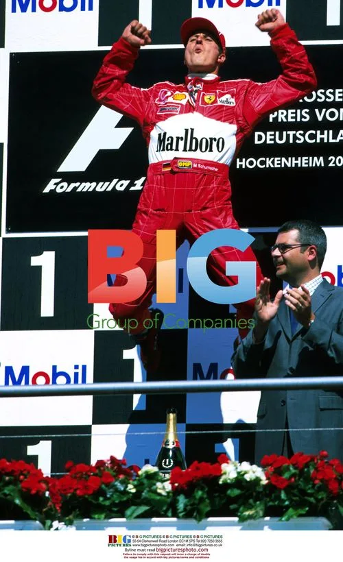 Michael Schumacher celebrates first Ferrari win