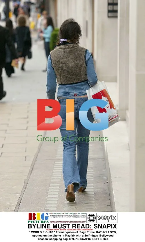 Kathy Lloyd in Mayfair with Selfridges bag