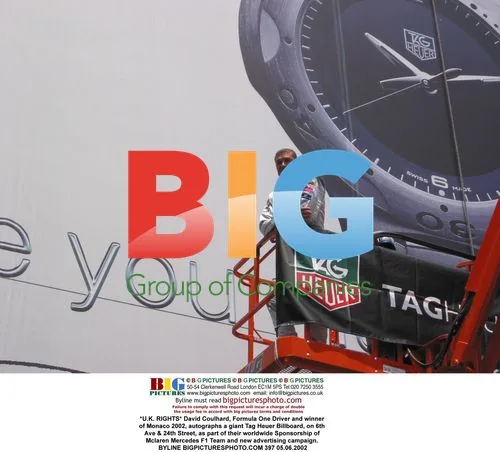 David Coulhard autographs Tag Heuer billboard