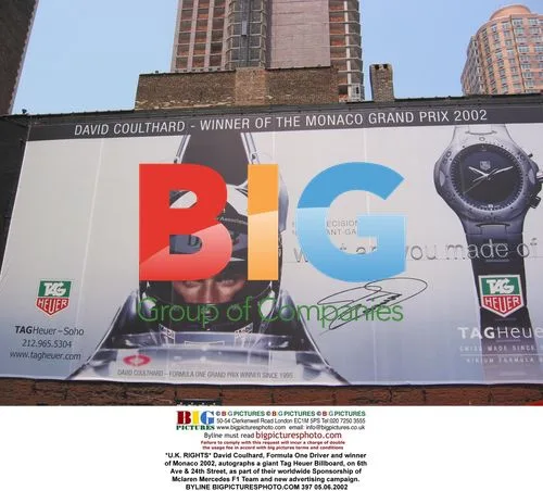 David Coulhard autographs Tag Heuer billboard