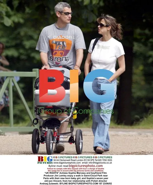Sophie Marceau and Jim Lemley with children in park