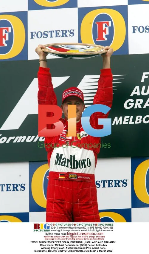 Michael Schumacher Holds Trophy Aloft After Grand Prix Win