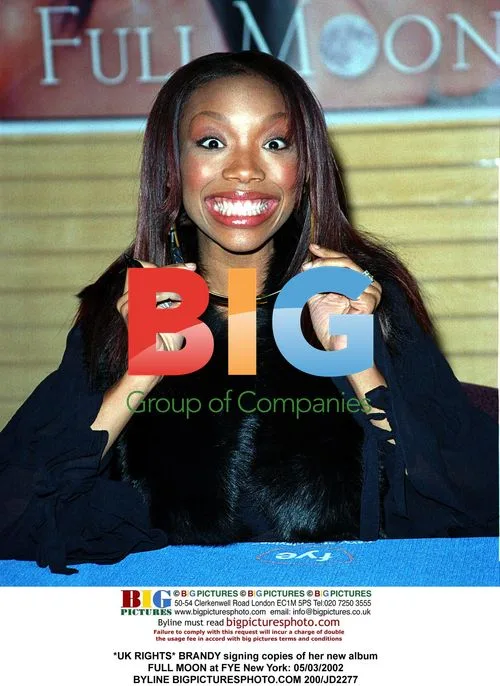 Brandy signing album at FYE New York