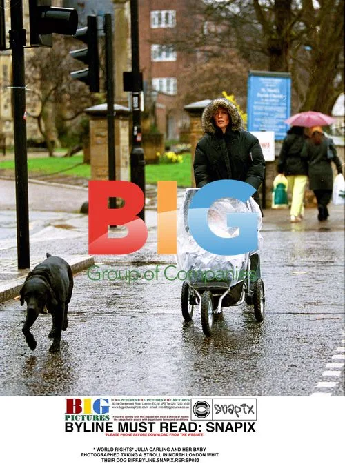 Julia Carling and baby stroll with dog Biff in North London