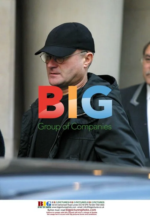 Phill Collins Leaves Paris Hotel with Family