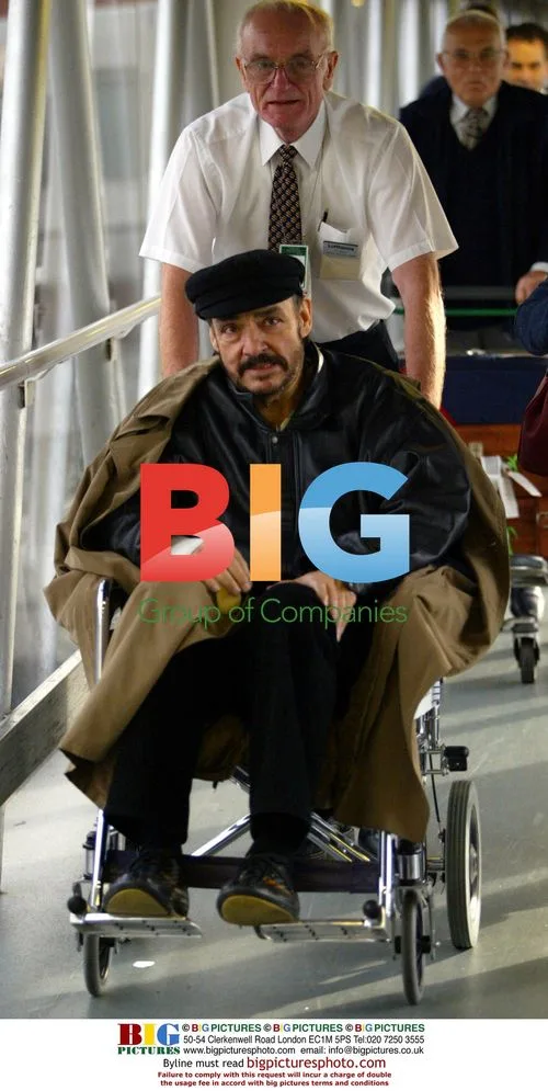 Actor John Rhys-Davis in Wheelchair at Airport