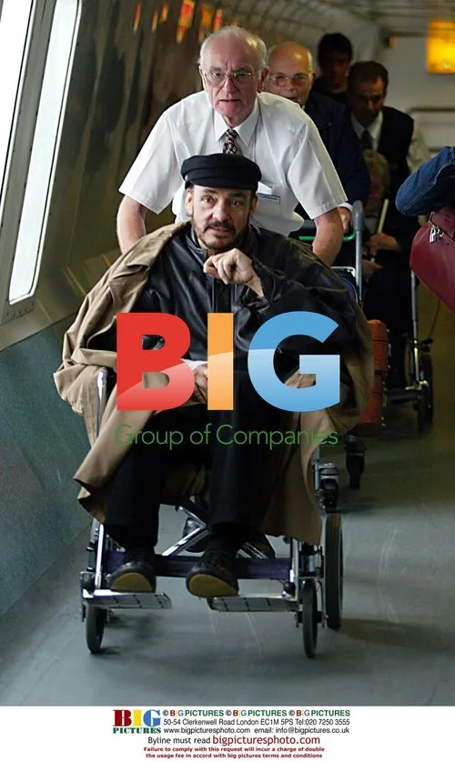 John Rhys-Davies in wheelchair at airport