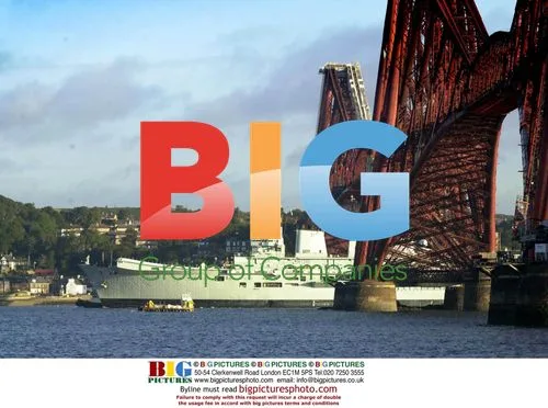 Aircraft carrier 'Illustrious' passes under bridges