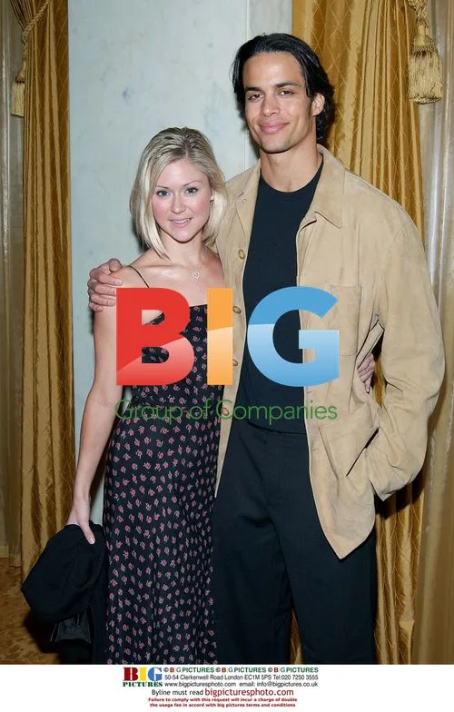 Smiling celebrity duo poses at event