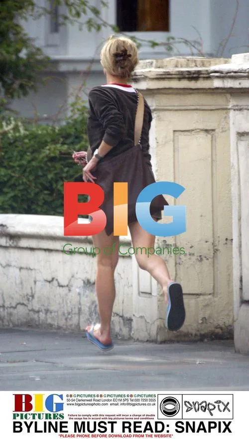 Model Laura Bailey Hurries Down the Street