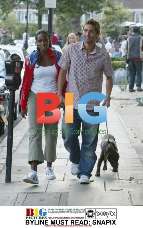 Shaznay Lewis and fiancee Christian walk with puppy