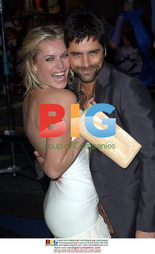 Rebecca Romijn-Stamos and John Stamos at X2 Premiere