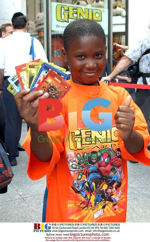 Young card buyer holds new Marvel cards