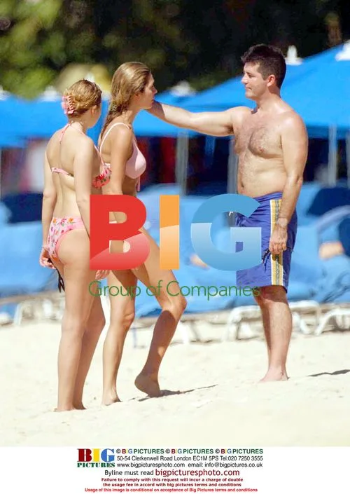Simon Cowell chats with blonde on Caribbean beach
