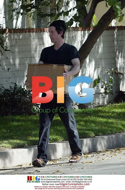 Keanu Reeves takes trash to dumpster