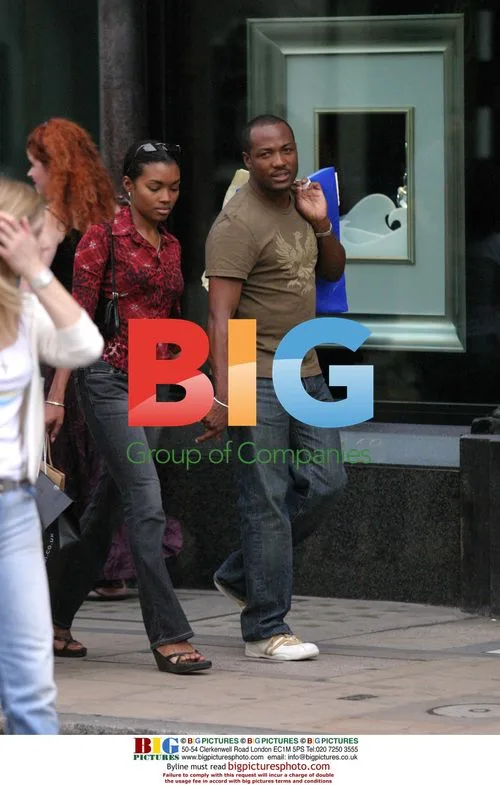 Brian Lara and girlfriend shopping in London