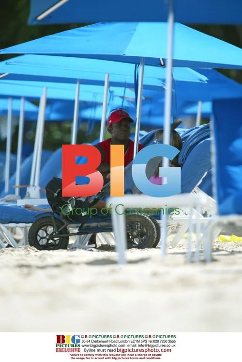 Jordan, Dwight Yorke, and Baby Harvey on Caribbean Beach