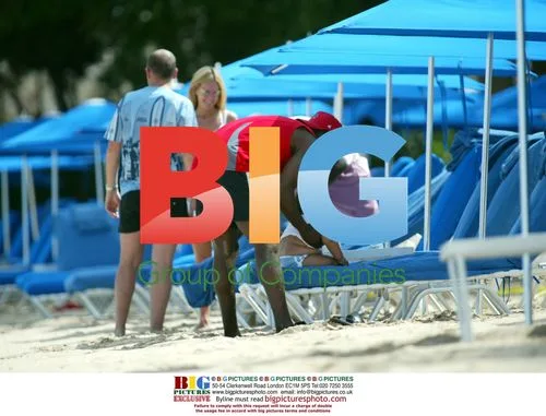 Jordan, Dwight Yorke and baby Harvey on Caribbean beach