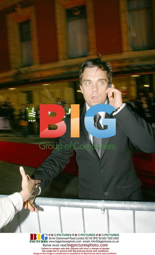 Robbie Williams greets a cyclist's wife