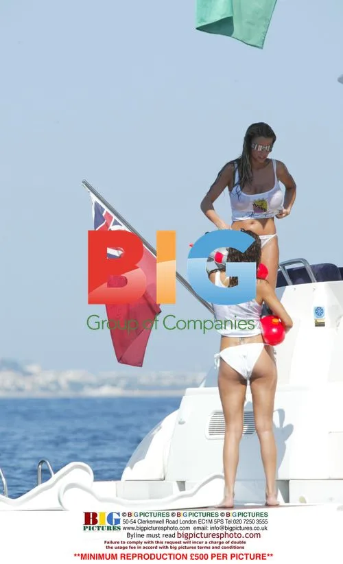 Models Jordan and Jerri Byrne in water gun fight on yacht