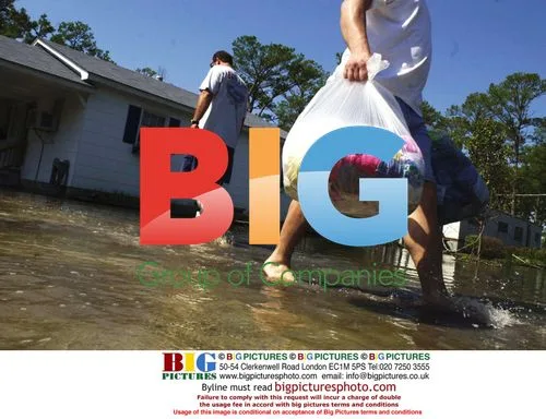 Brothers remove flood-damaged items