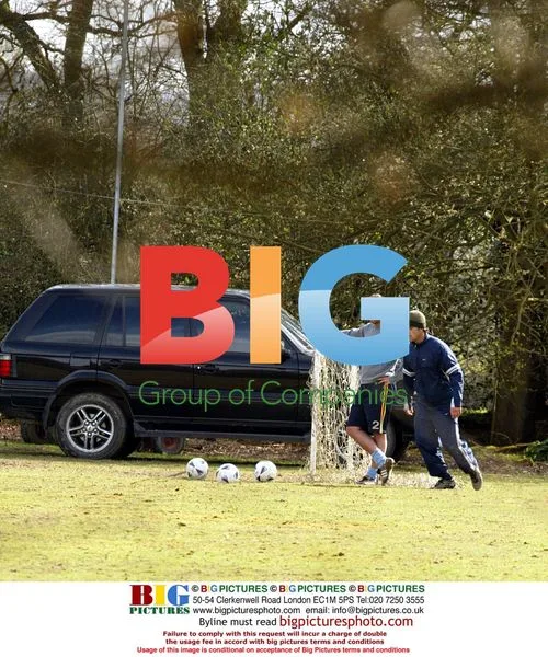 Robbie Williams and Jonathan Wilkes playing football