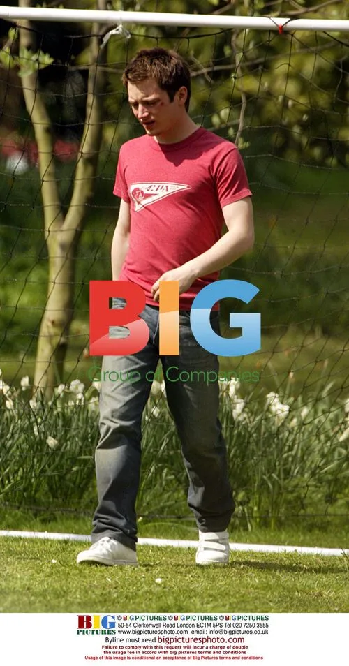 Elijah Wood playing football on set