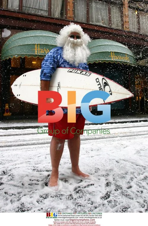 Santa Poses with Surfboard Outside Harrods