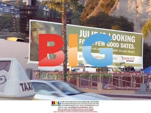 Julie Koehnen and Cory Romero under billboard