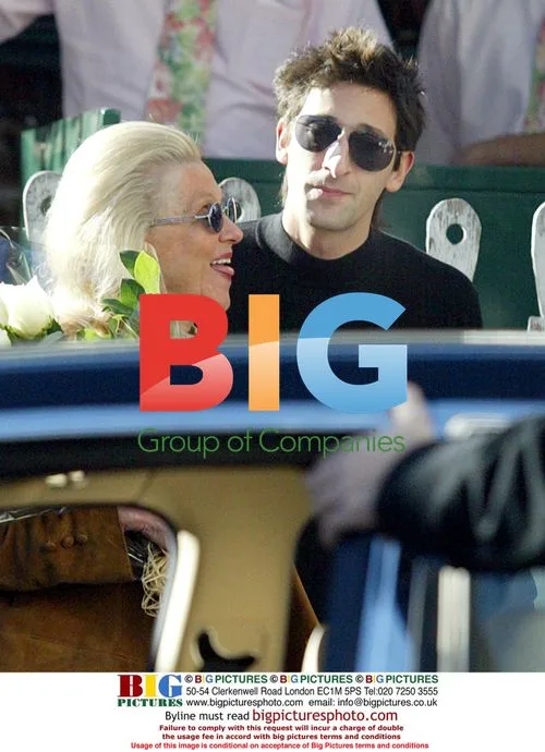 Adrien Brody kissing elderly woman outside restaurant