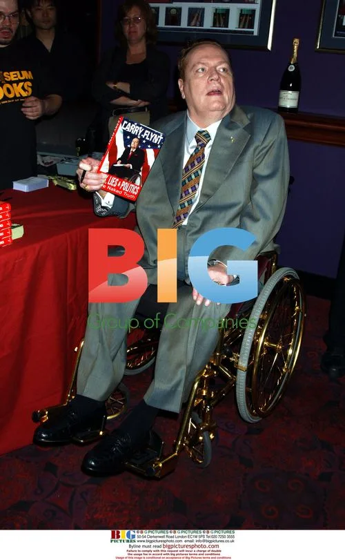 Larry Flynt signs books at Hustler Club