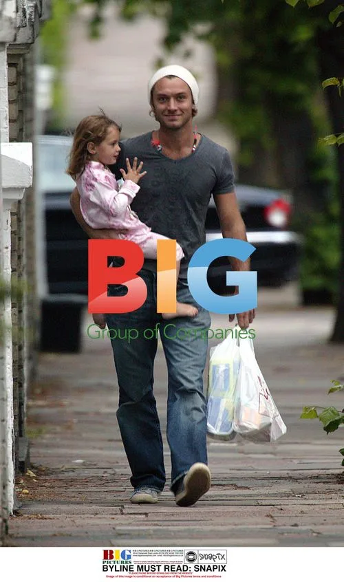 Jude Law Carries Daughter Iris in London