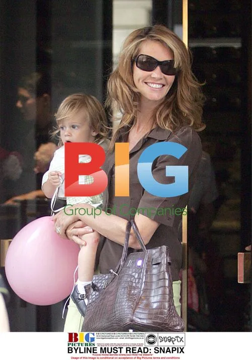 Elle Macpherson with son leaving London restaurant