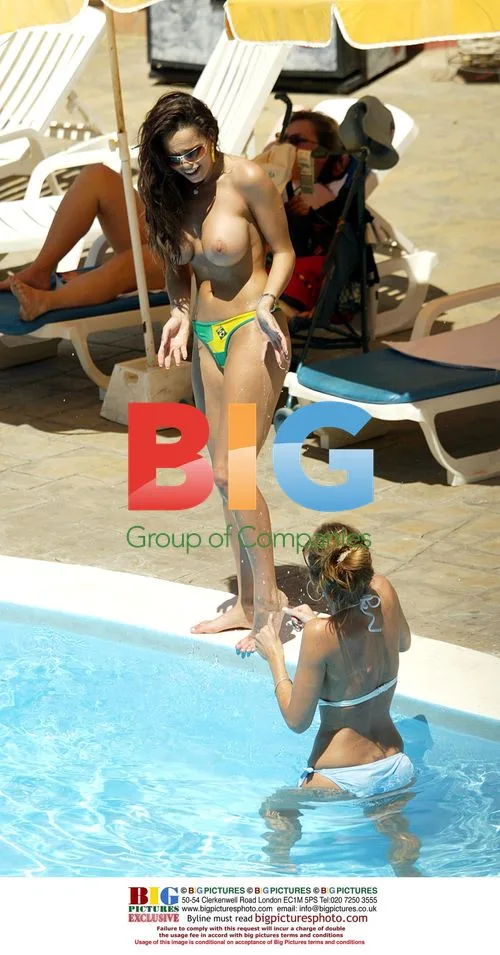 Models Jerri and Michelle tanning poolside in Tenerife