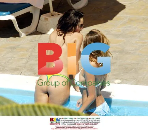 Models Jerri Byrne and Michelle Tanning by Pool in Tenerife