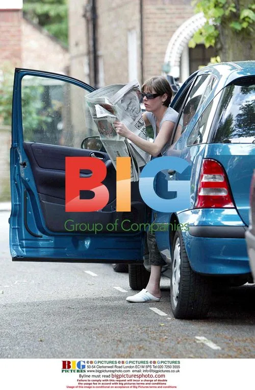 Elaine Lordan Hiding Face with Newspaper