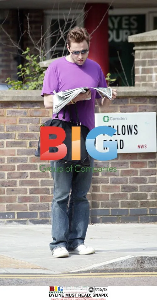 David Walliams Reading Newspaper in London